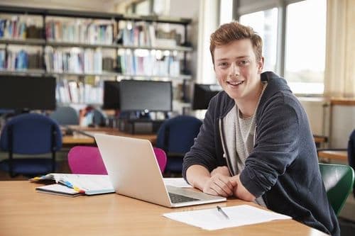 portrait-male-student-working-laptop-college-library_720